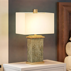 A luxury bed with a unique lighting fixture, the UEX7540 Mediterranean Table Lamp, enhancing its elegance.