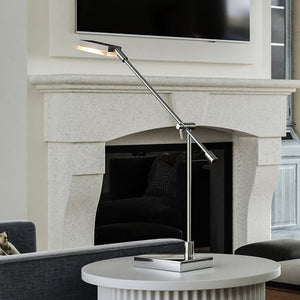A unique 10''W x 4''D x 26''H lighting fixture from the Cape May Collection by Urban Ambiance, showcasing a polished chrome finish, in a living room with a
