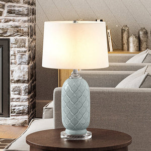 A gorgeous Urban Ambiance UEX7560 Mid-Century-Modern Table Lamp with a Pale Blue Finish from the St. Francisville Collection, adding a unique touch of luxury to any