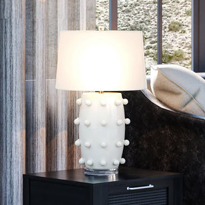 A unique and gorgeous UEX7710 Transitional Table Lamp from the Cold Spring Collection by Urban Ambiance in a living room with a white glazed finish.