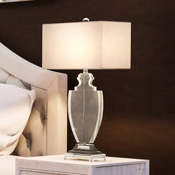 A beautiful lighting fixture, the UEX7900 Glam Table Lamp, adorns a bed.