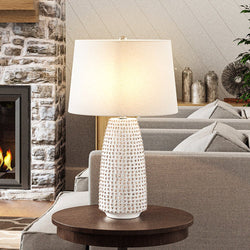 A gorgeous living room with a unique fireplace and a beautiful Urban Ambiance UEX7990 Transitional Table Lamp 16''W x 16''D x 29''H, White and