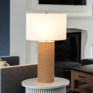A beautiful UEX8100 Scandinavian Table Lamp from the St. Cloud Collection sits on a table in a living room.