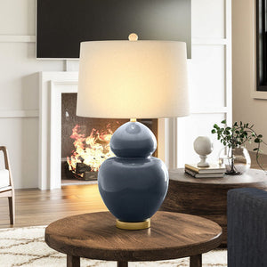A beautiful lighting fixture, the Urban Ambiance UEX8130 Glam Table Lamp, adds elegance to a living room with a fireplace.