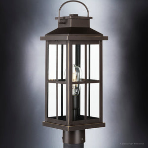 An Urban Ambiance UHP1293 Transitional Outdoor Post Light 20.25''H x 7''W, Olde Bronze Finish, Anaheim Collection lantern with a clear glass lighting fixture.