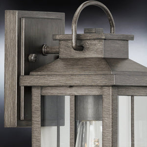 A Transitional Outdoor Wall Sconce from the Anaheim Collection with Aged Pewter Finish, creating an Urban Ambiance.