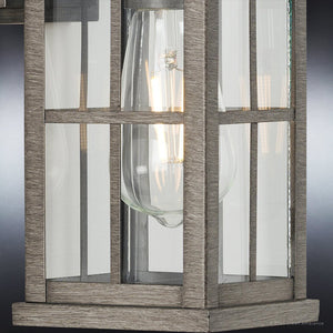 A Unique Outdoor Wall Sconce 12''H x 5''W, Aged Pewter Finish, Anaheim Collection with a glass shade.