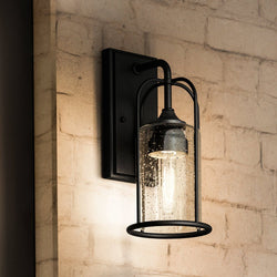 A beautiful Farmhouse Outdoor Wall Sconce with a glass shade.
