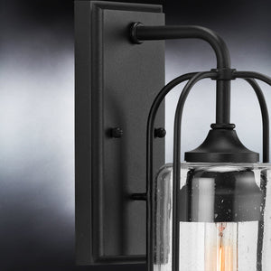 A unique midnight black farmhouse outdoor wall sconce with a clear glass shade from the Urban Ambiance UHP1300 Henderson Collection.