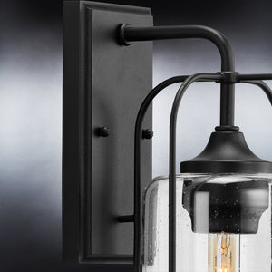 A gorgeous UHP1301 Farmhouse Outdoor Wall Sconce with a clear glass bulb, Midnight Black Finish, Henderson Collection by Urban Ambiance.