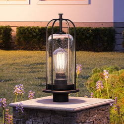 An urban ambiance lighting fixture with a glass globe on top of a stone wall, delivering a beautiful and luxurious atmosphere.