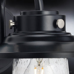 A gorgeous UHP1320 Coastal Luxury Outdoor Wall Sconce from the Santa-Ana Collection, featuring a midnight black finish and clear bulb.