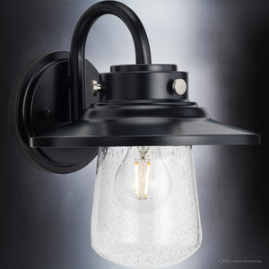 A unique lighting fixture, the UHP1320 Coastal Outdoor Wall Sconce from the Santa-Ana Collection by Urban Ambiance, features a midnight black finish and clear glass bulb.