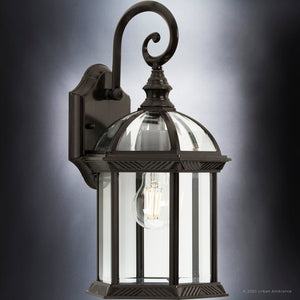 A unique outdoor wall sconce with a clear glass shade in an Olde Bronze Finish.