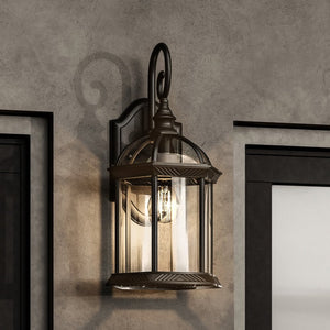 An Urban Ambiance UHP1372 Transitional Outdoor Wall Sconce 18.125''H x 9.75''W, Olde Bronze Finish, lighting fixture on a wall next to