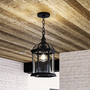 A beautiful Urban Ambiance UHP1378 Transitional Outdoor Pendant 13.625''H x 7.5''W, Midnight Black Finish, Greensboro Collection lantern hanging from a wooden
