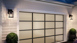 Modern garage door with frosted glass panels and black grid framing, flanked by Urban Ambiance UHP1380 Farmhouse Outdoor Wall Sconces in Olde Bronze from the Macon Collection and potted topiary bushes on each side.
