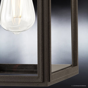 Close-up of the Urban Ambiance UHP1381 Macon Collection Farmhouse Outdoor Wall Sconce, 13.625''H x 7.125''W, featuring an Olde Bronze finish and marine-grade construction with a visible bulb against a blurred gray background.
