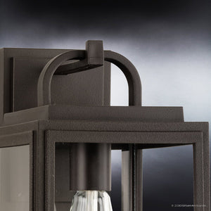 Close-up of the UHP1381 Farmhouse Outdoor Wall Sconce from Urban Ambiance’s Macon Collection, featuring a marine-grade, olde bronze finish and clear glass panels in a rectangular frame, measuring 13.625