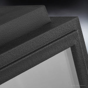 Close-up of the textured, corrosion-resistant midnight black frame and corner details of the Urban Ambiance UHP1386 Farmhouse Outdoor Wall Sconce (13.625''H x 7.125''W), Macon Collection, featuring marine-grade construction.