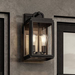 The Urban Ambiance UHP1387 Farmhouse Outdoor Wall Sconce, 17''H x 9''W from the Macon Collection, features a midnight black, marine-grade finish and displays two exposed bulbs on a gray concrete wall.