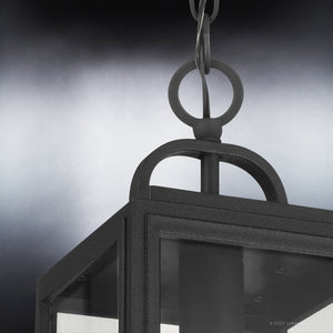 Close-up of the Urban Ambiance UHP1388 Farmhouse Outdoor Pendant (15.375''H x 7''W) in Midnight Black from the Macon Collection, marine-grade construction, featuring a metal loop and chain against a blurred gray background.