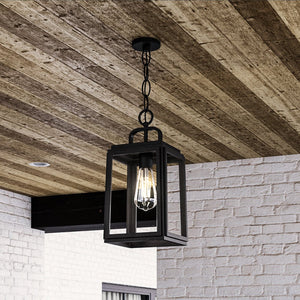 A beautiful UHP1388 Farmhouse Outdoor Pendant 15.375''H x 7''W, Midnight Black Finish, Macon Collection by Urban Ambiance hanging from a wooden ceiling