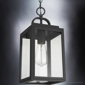 The Urban Ambiance UHP1388 Farmhouse Outdoor Pendant from the Macon Collection features marine-grade construction, a midnight black finish, clear glass panels, and a visible bulb in a 15.375''H x 7''W rectangular design.