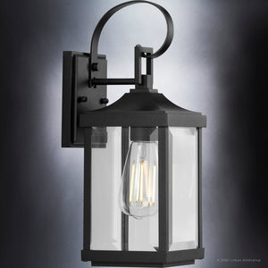 A gorgeous lighting fixture, the UHP1402 Transitional Outdoor Wall Sconce from the Calderdale Collection by Urban Ambiance features a midnight black finish and clear glass bulb.