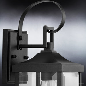 A gorgeous UHP1402 Transitional Outdoor Wall Sconce lamp 15.125''H x 5.5''W with a clear glass shade, Midnight Black Finish from the Calder