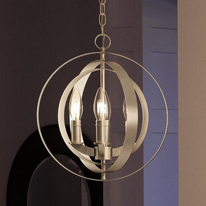 Illuminate your contemporary space with the Urban Ambiance UHP2320 Luxe Industrial Pendant from the Arezzo Collection, featuring three candle-style bulbs encased in interlocking steel rings with a stylish brushed nickel finish, all elegantly suspended from a chain; measures 11-3/4″ high by 10-1/8″ wide.