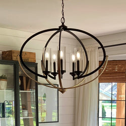 A beautiful lighting fixture, UHP2351 Mediterranean Chandelier, hanging over a dining room table.