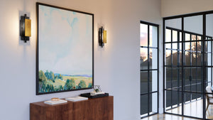 A modern living room with a unique and gorgeous lighting fixture, the UHP3863 Contemporary Wall Sconce 15.125''H x 5.375''W, Midnight Black