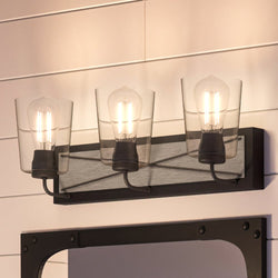 An Urban Ambiance UHP3904 Farmhouse Bath Light 8.25''H x 24.75''W, Charcoal Finish, Berkeley Collection with three beautiful lights and a mirror.