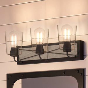 An Urban Ambiance UHP3904 Farmhouse Bath Light 8.25''H x 24.75''W, Charcoal Finish, Berkeley Collection with three beautiful lights and a mirror.