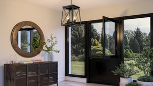An beautiful entryway with a unique UHP3921 Industrial Chandelier 21''H x 15.5''W, Midnight Black Finish, Berkeley Collection by Urban Ambiance and a large mirror