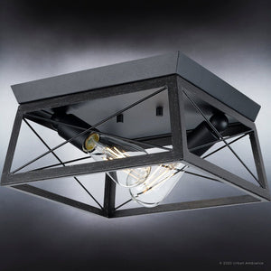 A gorgeous UHP3924 Industrial Ceiling Light 6''H x 12''W, Midnight Black Finish, Berkeley Collection lighting fixture with two bulbs in it.