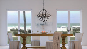 A luxurious dining room with a gorgeous UHP3930 Farmhouse Chandelier 26.875''H x 25.5''W in Midnight Black Finish, complemented by the Maryborough Collection