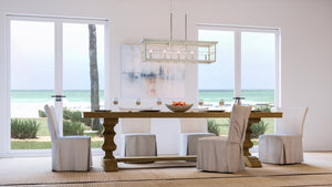 A dining room with a unique and gorgeous UHP3950 Modern Farmhouse Chandelier 11''H x 40''W, Brushed Nickel Finish, Ballina Collection from Urban Ambiance table