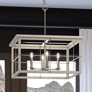 A beautiful Urban Ambiance UHP3951 Modern Farmhouse Chandelier, with a brushed nickel finish, from the luxurious Ballina Collection hanging in a room with mountains in the background.