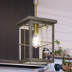A unique UHP3956 Modern Farmhouse Pendant 19.375''H x 10.375''W, Distressed Brass Finish, Ballina Collection by Urban Ambiance hanging over a kitchen