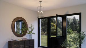 A black doorway with a unique UHP3973 Modern Farmhouse Chandelier 23''H x 15''W lighting fixture from Urban Ambiance and a mirror and a potted plant