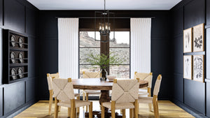 A luxurious dining room with a gorgeous black chandelier.