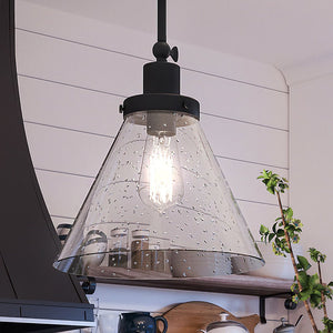 A kitchen with the gorgeous UHP4000 Traditional Pendant 12.5''H x 12''W lighting fixture, Midnight Black Finish, Pawtucket Collection hanging over a stove from Urban Amb