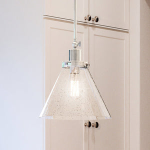 A kitchen with white cabinets and a beautiful UHP4001 Traditional Pendant 12.5''H x 12''W, Polished Nickel Finish, Pawtucket Collection pendant light by