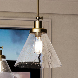 Two beautiful UHP4002 Traditional Pendant 12.5''H x 12''W, Olde Brass Finish light fixtures in a room with a window, by luxury brand Urban Ambiance.