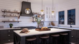 A gorgeous kitchen with Urban Ambiance's UHP4011 Minimalist Pendant 8.75''H x 8''W, Brushed Bronze Finish, Canton Collection cabinets and black counter tops.
