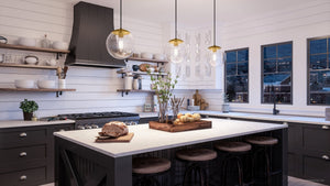A unique lighting fixture in a black and white kitchen with UHP4014 Minimalist Pendant 10.5''H x 10''W, Brushed Bronze Finish, Canton Collection pendant