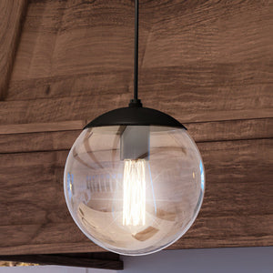 A beautiful UHP4015 Minimalist Pendant 10.5''H x 10''W, Midnight Black Finish, Canton Collection hanging from a wooden ceiling. Brand Name: Urban Ambiance.