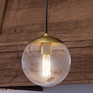 A beautiful UHP4017 minimalist pendant lamp from the Canton Collection with a glass globe hanging from a wooden ceiling.